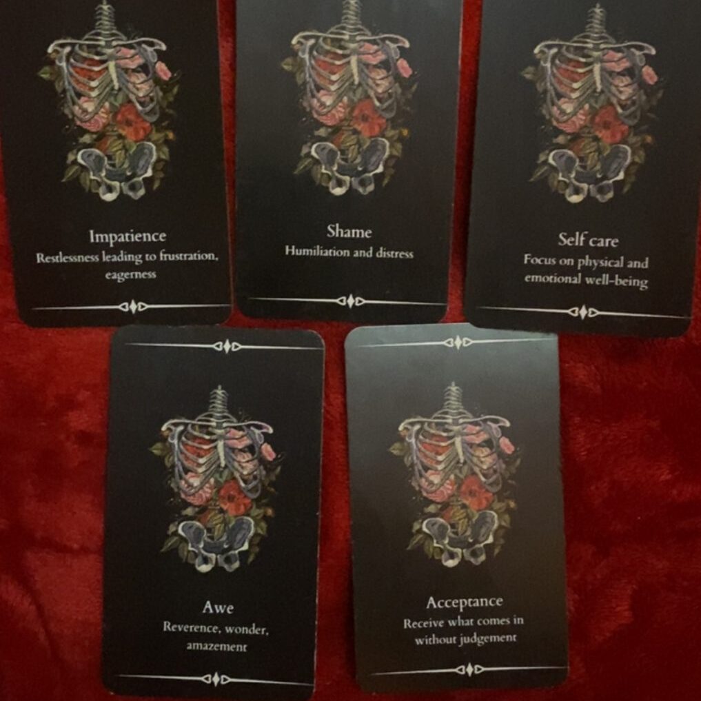 Five tarot cards with dark backgrounds, each featuring intricate, red-tinged illustrations and titles.